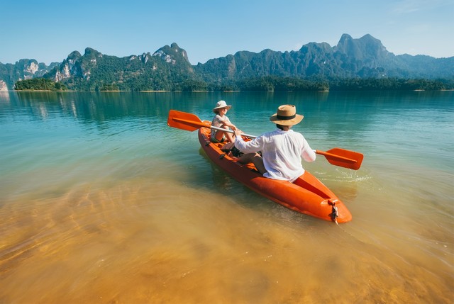 Mother and son floating on kayak together 