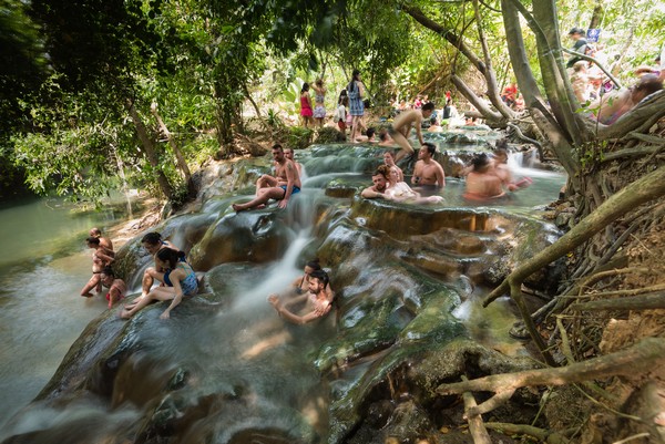 People enjoy Klong Thom Hot Spring Waterfall in Krabi