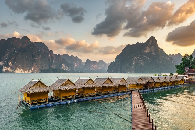 Raft houses on Cheow Lan lake in Khao Sok National Park at sunset, Thailand